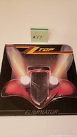 Front cover of ZZ Top Eliminator vinyl record showing car artwork and sleeve corner cut.