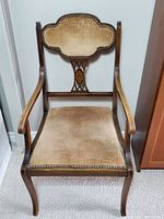 Front view of vintage accent chair showing velvet upholstery and wood inlay