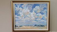 Full view of framed painting showing sky, clouds, horizon and signature
