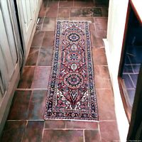 Full-length view of runner laid on tile floor, showing overall pattern and proportions.