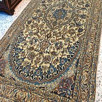 Angled view showing floral motif and border detail on one end.