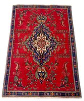 Full view of rug laid flat on neutral floor showing entire design and border