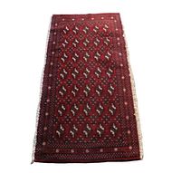 Full view of the Turkmen back rest rug showing the all-over repeating gul pattern and fringed edges