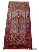 Full view of handwoven Zanjan rug with bordered geometric pattern and central medallion in beige, brown, cream, yellow, navy blue, salmon colors.