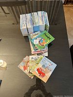 Top view of stacked children's books showing a neat collection including Bambi and other titles.