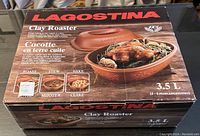 Front of the box showing Lagostina Clay Roaster with food, capacity 3.5 liters, for 4-6 people, uses include roasting, stewing, baking.