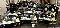 Wide shot of all 10 boxes of NOMA string lights stacked together showing packaging and quantity