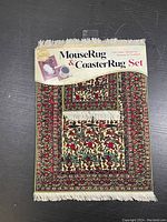 Front view of the Mouse Rug and Coaster Rug set with original packaging showing design and text.