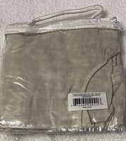 Apron folded inside its original packaging with a barcode label.