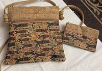 Handbag and change purse shown together on a fabric background, showcasing overall size and design.