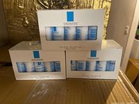 Three white boxes showing 15 sample size bottles each of La Roche-Posay face cleanser.