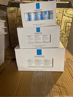 Three stacked white boxes of La Roche-Posay samples, each showing blue logo and product info.