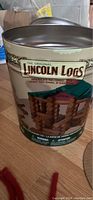 Photo of original metal anniversary tin with Lincoln Logs branding and vintage style logo and design.