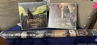 Pagan: Fate of Roanoke and Beyond the Palisades expansion boxed games next to rolled-up playmat
