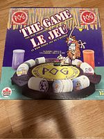Front box cover of the POG game showing the game title, logo, cartoon character and depiction of game pieces.