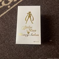 White Sailor Moon Honey Salon presentation box with gold logo and silhouette on top.