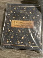 Front view of the Unique brand sewing advent calendar with deer print and slogan 'Let it sew, let it sew, let it sew, Faufilier, faufilier, faufilier!'