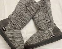Pair of grey MukLuks winter boots showing knit fabric and button accents.