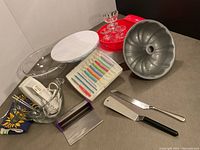 Full lot with baking and cake decorating equipment including Wilton tool set, cake stand, hand mixer, Bundt pan, cake servers