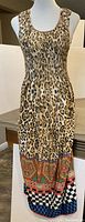Front view of full-length dress showing leopard print and colorful patterned hem on mannequin