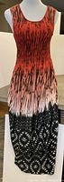 Front view of the sleeveless full-length dress with red to black gradient and feather/animal print pattern.