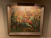 Full view of framed print 'The Tangled Garden' showing colorful detailed garden scene in carved frame with attached light above.