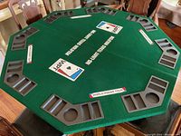 Octagonal green felt World Poker Tour poker table top with plastic cup holders and chip trays for 8 players