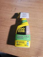 Front view of the Goo Gone Grout & Tile Cleaner spray bottle showing brand, product name, and key product info.