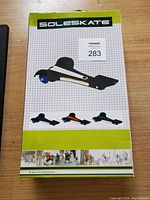 Box packaging showing Sole Skate branding and product image with a 3-wheel skateboard in black with blue accents.