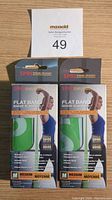 Two SPRI brand medium resistance flat bands in original packaging with a MaxSold lot number above