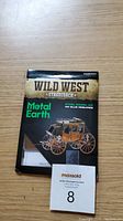 Front side of the sealed Metal Earth Wild West Stagecoach steel model kit box showing the image of the model and branding.