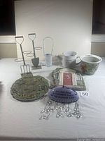 Full view of all items: planters, plaques, garden stakes, and garden sign with wind chimes placed on white background.