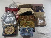 Overview of all 15 vintage and retro clutch purses and wallets arranged together showing various materials including beaded, fabric, leather, and metallic textures.
