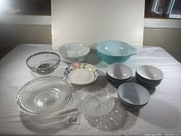 Overview photo showing all bowls arranged on white backdrop, including the Pyrex bowl, black and white plastic bowls, crystal and china bowls.