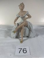 Front view of the Wallendorf porcelain sitting ballerina figurine showing her dress and pose.