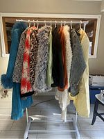 Full set of eleven coats displayed on rack