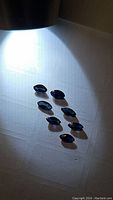 Seven marquis cut blue sapphire gemstones displayed under white light showing deep royal to midnight blue color.
