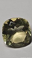 Top view of the natural lemon citrine gemstone showing the cushion cut and clear yellow color.