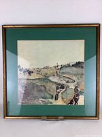 Full view of the framed watercolour painting showing landscape scene with a green mat and gold frame.