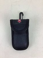 Victorinox branded black nylon case with flap and clip for carrying the golf tool