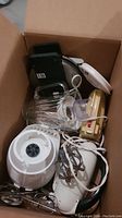 Box containing all items showing blender jar, hand mixers, waffle maker