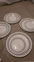 Four Corelle City Block plates laid on surface, showing pattern and size variation.