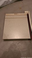 Full top view of Boston 2618 manual paper cutter showing the white grid base and measurement scales.