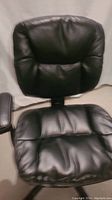 Front view of black executive chair showing cushioned seat and padded backrest