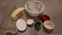 Photo showing all items in the lot including the telephone, ceramic bowls, wire strainer, and small dishes.