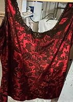 Front view of size large ladies cami in red with black lace trim, floral pattern, silky jacquard fabric.