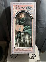 Vanessa porcelain doll in original decorated box with floral design and clear display window.
