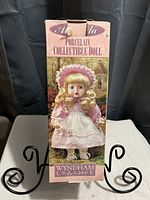 Original box of Wyndham Lane porcelain collectible doll showing image of doll and branding.