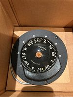 Top view showing compass dial with cardinal directions and degree markings, Danforth brand and model information.