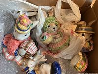 Group photo of ceramic Easter bunny statues and decorative eggs packed in box with bubble wrap and plastic bags
